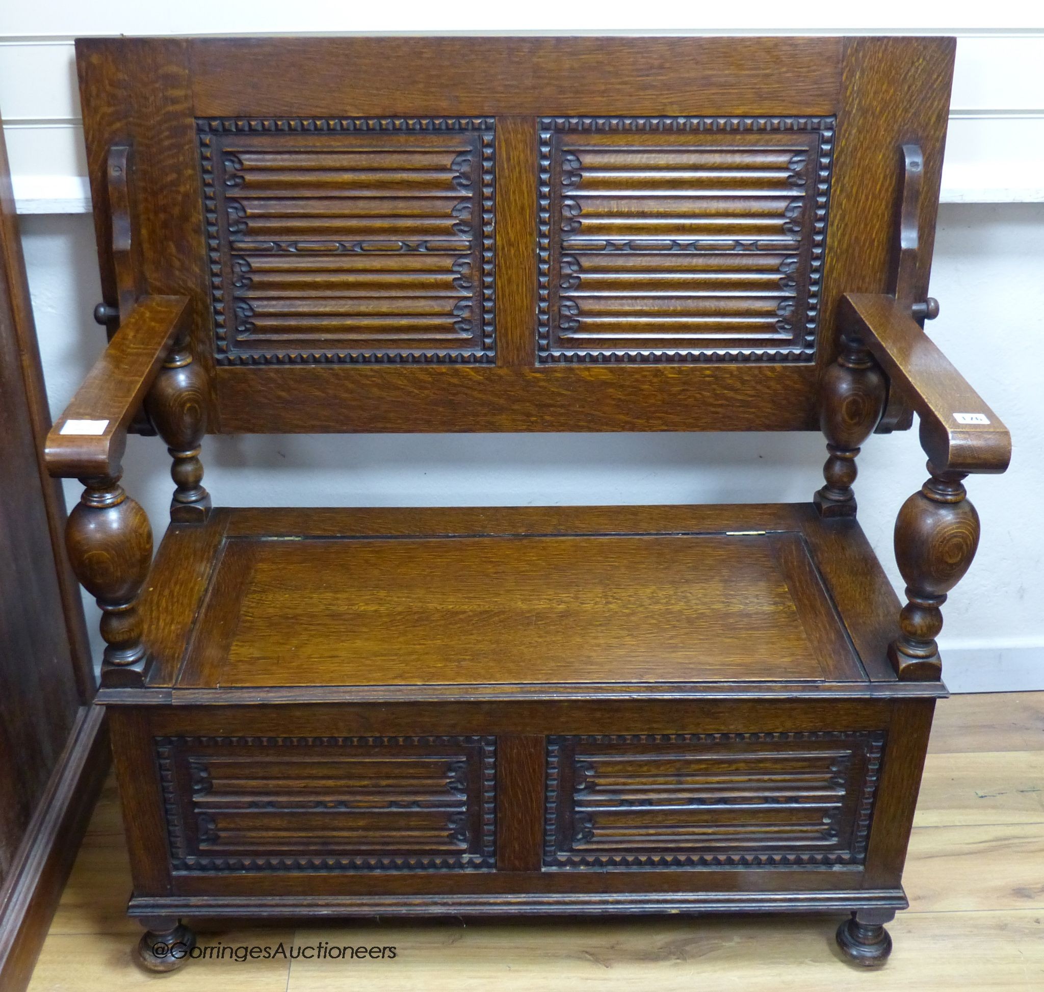 A 17th century style oak box seat monk's bench, width 107cm, depth 51cm, height 105cm